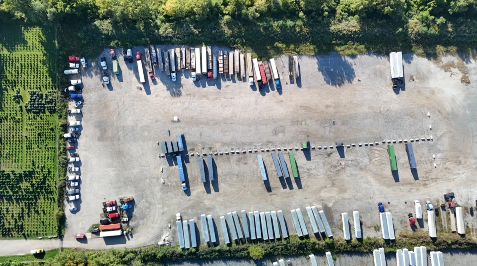 Top-down drone view of the lot with trailers and containers lined up in clear rows
