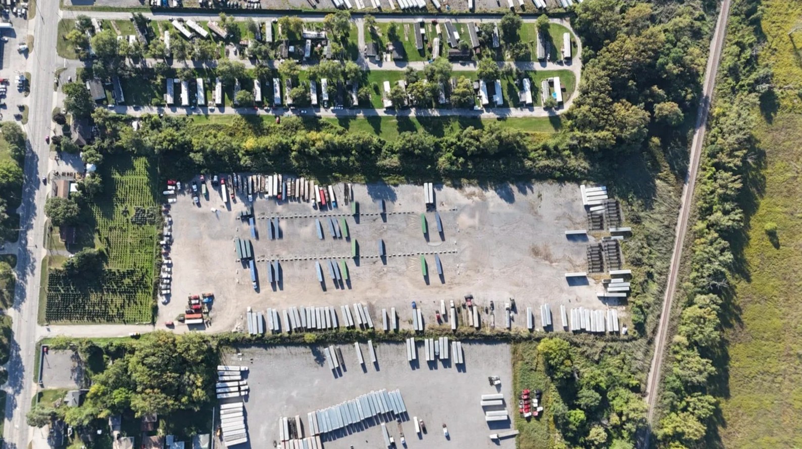 Aerial view of the Gary Truck Park yard between Ridge Road and the rail line, with the neighboring lots beside it